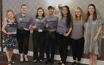 Students holding award